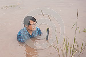 Flood water in ric field and pond, Farmer men working in nature water pond  of rice paddy field