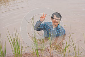 Flood water in ric field and pond, Farmer men working in nature water pond  of rice paddy field