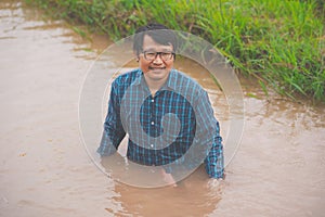 Flood water in ric field and pond, Farmer men working in nature water pond  of rice paddy field