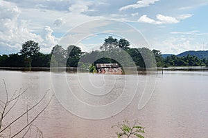 Flood water to the edge of the house\'s roof in Thailand. El NiÃ±o and La NiÃ±a phenomena. photo