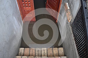 Flooded basement after the massive rain. Flooded cellar with wooden door full of dirty water