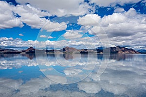 Flooded Bonneville Salt Flats in Utah create a mirror reflection scene on the water, dreamscape like look to the photo