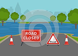 Flooded city road with warning sign and cones. British closed road sign.