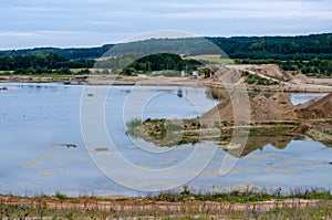 Flooded gravel pit. Extraction of natural resources