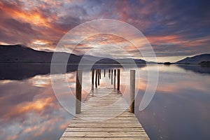 Flooded jetty in Derwent Water, Lake District, England at sunset