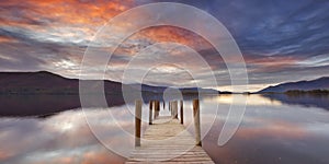 Flooded jetty in Lake District, England at sunset