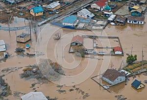 A flooded neighborhood with houses in the background, dam break