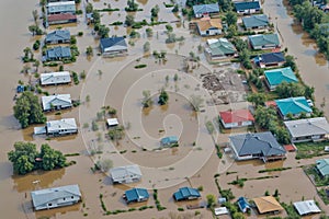 A flooded neighborhood with houses in the background, dam break