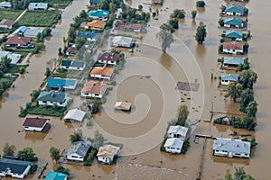 A flooded neighborhood with houses in the background, dam break