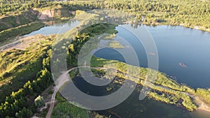 Flooded and overgrown sand quarry. Lush green summer landscape for outdoors vacation, hiking, camping or tourism. Volokolamsk