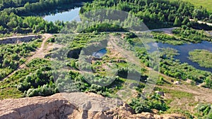 Flooded and overgrown sand quarry. Lush green summer landscape for outdoors vacation, hiking, camping or tourism. Volokolamsk