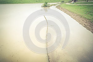 Flooded riverside pathway trail near levee with overflow garage