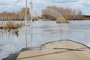 Flooded road in the countryside in springtime. Natural disaster.