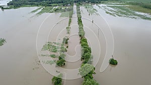 Flooded road heavy rain flooding taken during drone flight overflowing river