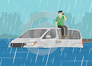 Flooded road and rainy weather conditions. A frightened male character climbed and sits on car roof. Young driver calls emergency.