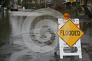 Flooded sign sits on a flooded street