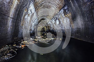 Flooded by wastewater sewage collector of underground river