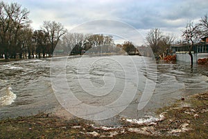 Flooding of river in spring in town during melting of snow. Natural disaster