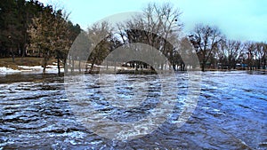 Flooding of river in spring in town during melting of snow. Natural disaster