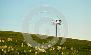 The floodlight in the evening with a soft yellow, blue sky.