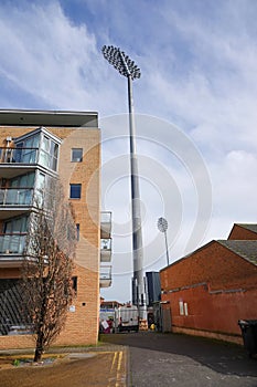 Floodlights at county cricket ground in English town. photo
