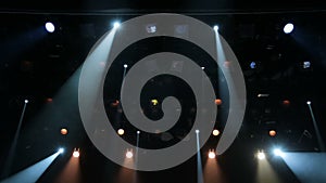 Floodlights, head, scanners, the theatrical smoke on the stage of the theater during the performance. Lighting equipment