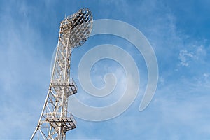 The floodlights at the stadium, afternoon, blue sky background