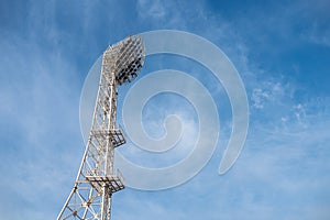 The floodlights at the stadium, afternoon, blue sky background