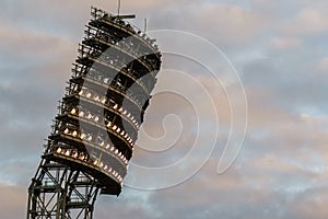 The floodlights at the stadium against the sky with clouds