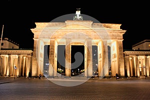 The floodlit Brandenburg Gate in Berlin with a few fleeting shad
