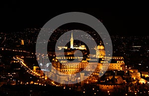 Floodlit Buda Royal Castle with bastions and Matthias Church