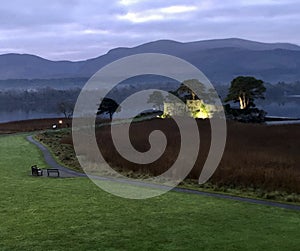 Floodlit Castle against a Mountain Sunset