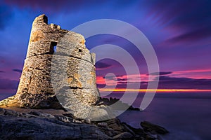 Floodlit Genoese tower at Erbalunga in Corsica at sunrise