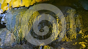 Floodlit stalactites inside sung sot cave at halong bay