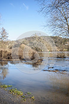 Floods on the river Main with strong currents near GroÃŸwallstadt in March 2020 in backlight