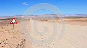 Floods sign 4x4 gravel road desert, Namibia