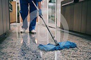 Floor being cleaned with blue mop cloth, emphasizing hygiene and cleanliness