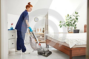 Floor care and cleaning services with vacuume cleaner at hotel room