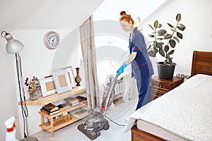 Floor care and cleaning services with vacuume cleaner at hotel room