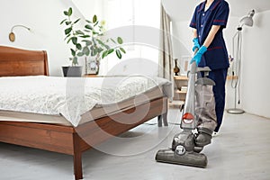 Floor care and cleaning services with vacuume cleaner at hotel room