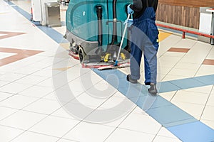 Floor care and cleaning services with washing machine in supermarket. disinfection and sanitization.