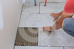 Floor ceramic tile installation with home construction working