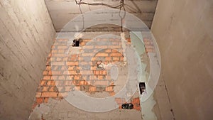 Floor heating pipes and repairs electricity wires at construction site of new house. Panorama shot.