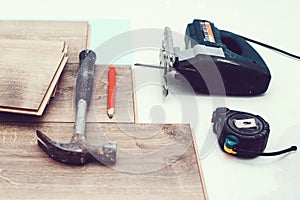 Floor installation. Wood laminate and tools. Floor background texture. Wooden laminate top view. Repair of a floor covering