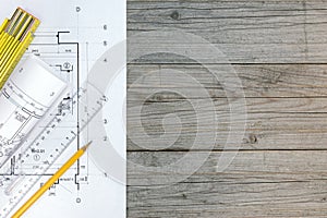 Floor plan, ruler and pencil on wooden table