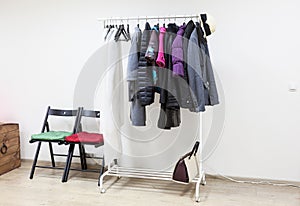 Floor rack with outerwear in interior hallway room, nobody