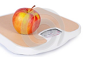 Floor scales with apple. Diet concept