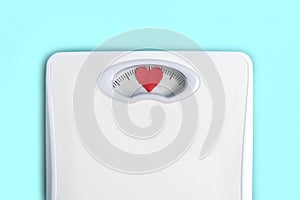 Floor scales with hearts instead of numbers. Love your body concept. Lifestyle motivation. Light blue background