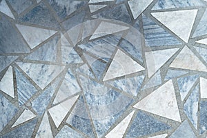 Floor or surface lined with marble slabs of triangular form.