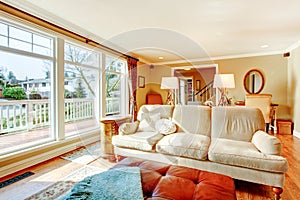 Floor-to-ceiling windows living room with a rustic beige couch